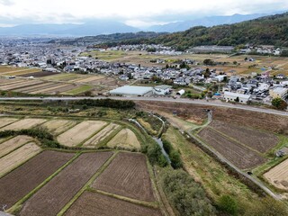 A rural area with a few houses and a road. The houses are spread out and there are no people visible