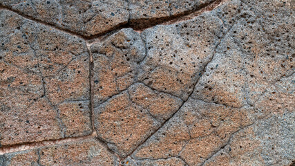 Obraz premium Red volcanic rock with cracks and pores