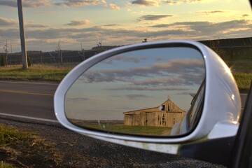 Reflection of Weathered Barn in Rearview Mirror Beautiful Sky 