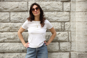 Stylish Young Woman in White Tank Top and Jeans