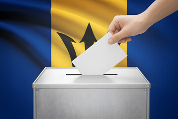 Voting in Barbados with hand casting ballot into box with flag background, democracy concept