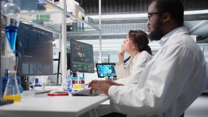 Laboratory manager oversees scientists working on computer, processing DNA data. Lab team leader and employees looking at genetic analysis diagnostics, brainstorming scientific breakthroughs, camera A - Powered by Adobe