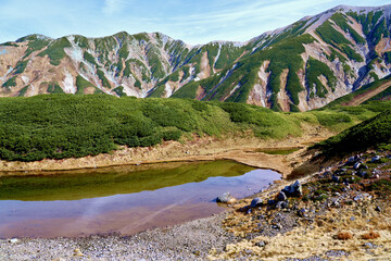 Scenery of the Tateyama Mountain Range and Midorigaike pond Murodo in autumn, Toyama Prefecture in Japan.