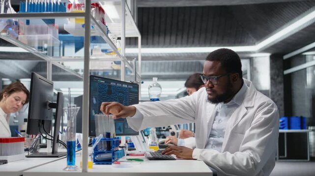 Medical technician investigates chemical sample properties using PC software in sterile laboratory setting. Research facility expert analyzing vial containing new compound using computer, camera A - Powered by Adobe