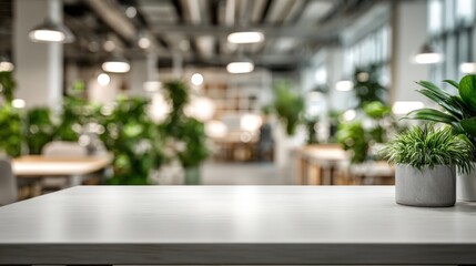 Fototapeta premium Clean White Tabletop with Potted Plants Overlooking a Bright, Modern, Open-Plan Office Space Background