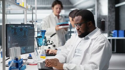 Laboratory bioinformatics scientist evaluates genetic markers using PC, analyzing sample properties. Man studies DNA strand mapping and chemical solution components using program on computer, camera B - Powered by Adobe