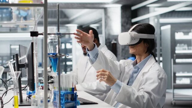 Lab specialist wearing VR headset equipment using chemical fluids for experiments. Chemist uses virtual reality device to simulate using solution laboratory glassware at workstation, camera B