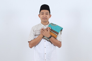 Portrait of Asian Muslim Man Greeting for Ramadan on White Background