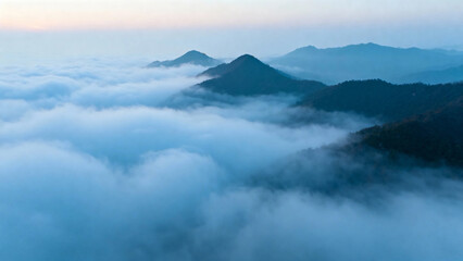 Mountain peaks rising above a sea of clouds at dawn