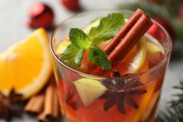 Tasty punch drink on light table, closeup. Christmas season