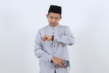 Muslim man checking smartwatch for appointment time