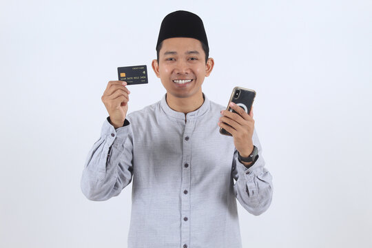 Muslim man with credit card and phone for online shopping
