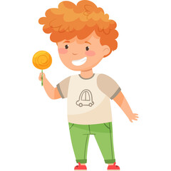 Smiling young boy with curly orange hair wearing a light colored t-shirt with a car graphic and green pants holding a yellow lollipop stick in his right hand on a white background