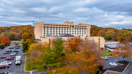 Autumn aerial image of a non-descript hotel with parking, location in the north eastern United States.