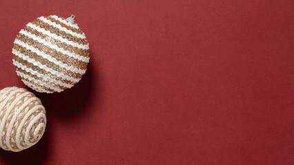 gold and white christmas ball on red background,christmas decoration on a red paper with copy space,Christmas holidays banner,Christmas background,christmas tree decoration