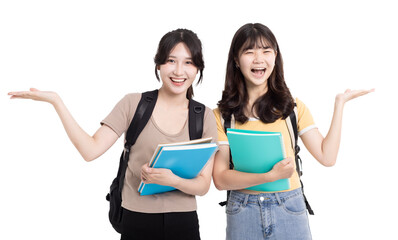 Two happy asian female students carrying notebooks and showing something