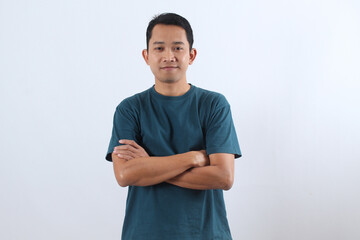 Confident young Asian man smiling with arms crossed isolated on white