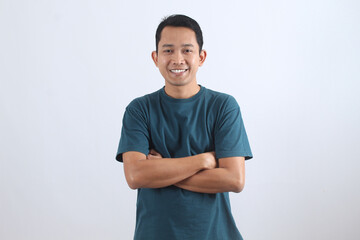 Confident Asian man smiling with crossed arms on white background