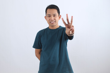 Smiling Asian man showing three fingers counting gesture