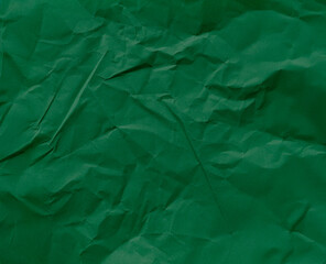 Crumpled green paper as background, top view.