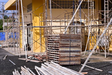 Scaffolding for building repair, A construction worker assembling scaffolding around  