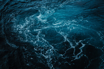 Ocean water background with foam. Ocean water splash. Not a calm