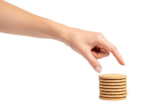 Woman's hand reaches for stack of round biscuits isolated on black . Isolated on transparent background, png