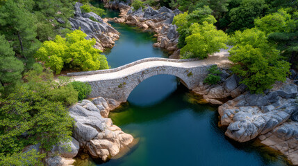 Historic stone bridge spans serene river, reflecting ancient strength and tranquil beauty. It evokes sense of timelessness, inviting viewers to contemplate history