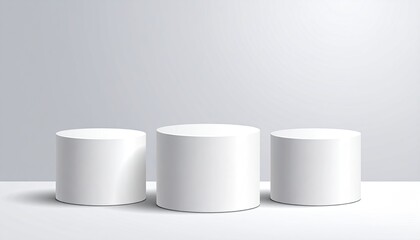 Three white cylindrical podiums stand on a white surface