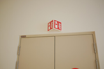 Emergency exit sign located above a closed door