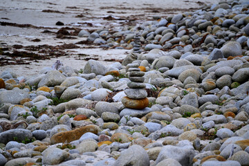 Zen Rock Cairn Stacked Among Smooth Gray Beach Stones