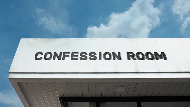 Confession Room word sign displayed on the exterior of a building under a clear blue sky, symbolizing privacy, reflection, spirituality, religious practice, and personal guidance
