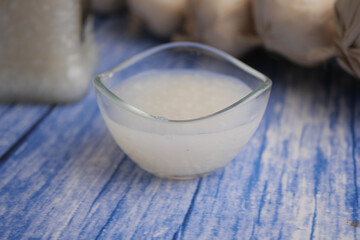 Homemade garlic paste on a blue wooden table surface