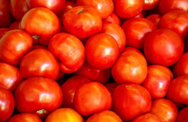 Bright pile of tomatoes close up