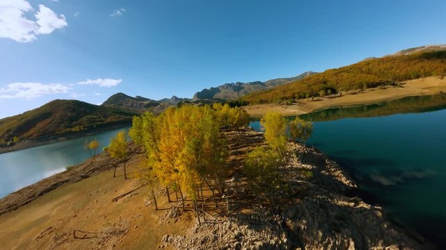 FPV drone flying over Embalse del Porma in autumn