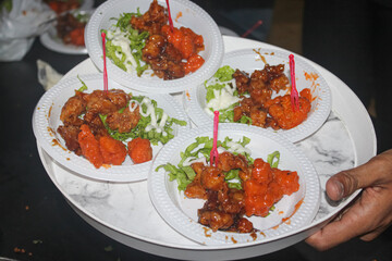 Platter of Glazed Chicken Bites and Orange Snacks