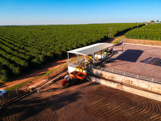 Aerial view of a large coffee farm in Brazil, showing the bean drying process on a patio with...