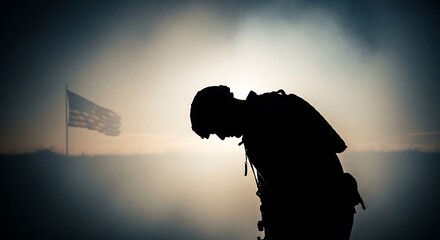 Silhouette of a soldier bowing head in solemn remembrance with an australian flag waving in the misty, atmospheric background