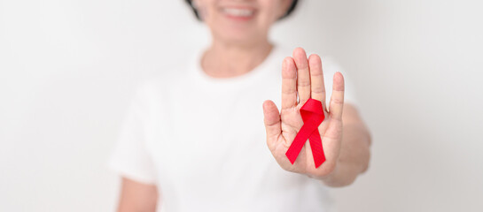 Elderly with Red Ribbon for December World Aids Day, MADD, October Red ribbon week, February Heart month, Marfan Syndrome, May Stroke awareness, March world TB Tuberculosis day and April Dare day