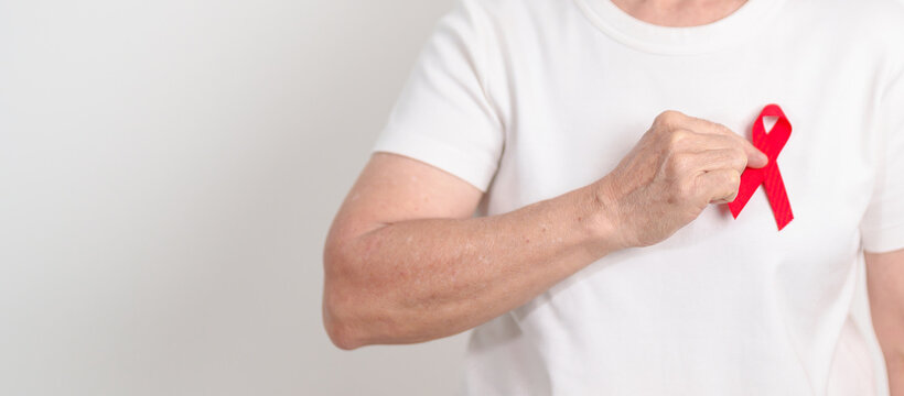 Elderly with Red Ribbon for December World Aids Day, MADD, October Red ribbon week, February Heart month, Marfan Syndrome, May Stroke awareness, March world TB Tuberculosis day and April Dare day - Powered by Adobe