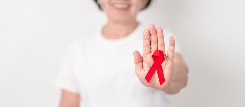 Elderly with Red Ribbon for December World Aids Day, MADD, October Red ribbon week, February Heart month, Marfan Syndrome, May Stroke awareness, March world TB Tuberculosis day and April Dare day