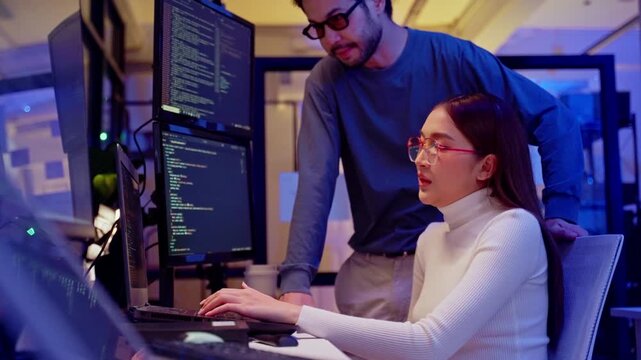 Asian software engineer or programmer team working late in development office,problem solving or algorithm of ai assistant helping for work.software developer,digital technology security concept