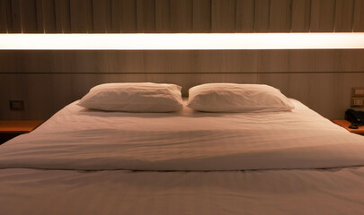 bed under warm light in hotel