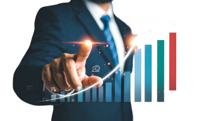 Businessman pointing at upward growth chart depicting 2025