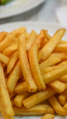 Fresh potatoes being cut and prepared for crispy homemade french fries in a kitchen