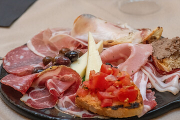 Traditional Italian charcuterie and cheese board served with fresh bread and garnishes