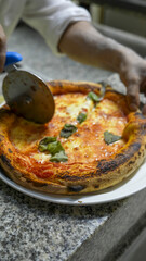 Inside view of a bustling pizzeria with delicious pizzas fresh out of the wood-fired oven