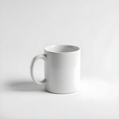 Fototapeta premium A simple, pristine white ceramic mug is presented against a clean, bright white background. The mug's handle is clearly visible, and the lighting is soft and even, highlighting its smooth surface and 