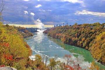 Rainbow Bridge and the Canadian Skyline on a Beautiful Fall Day with Gray Sky and Rising Mist