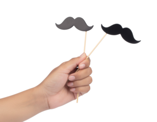 A hand holds two black mustache props on sticks against a dark background, ideal for playful photo booths or events.